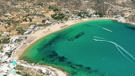 Aerial-view-of-water-sports-on-Mylopotas-Beach-on-Ios-Island,-Greece
