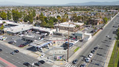 Aerial-drone-time-lapse-captures-activity-at-busy-Chevron-gas-station-showing-pumps-busy-intersection-and-central-location-in-the-city