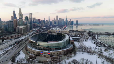 Drone-shot-in-front-of-the-Solider-field-stadium,-sunset-in-wintry-Chicago,-USA