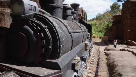 A-massive-black-clay-locomotive-located-in-the-Da-Lat-Sculpture-Museum,-also-known-as-the-Clay-Tunnel-or-Clay-Village-in-Vietnam
