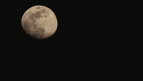 Waxing-gibbous-moon-phase-timelapse,-moving-on-dark-black-sky-at-night