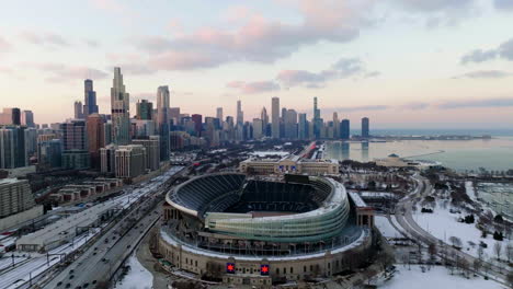 Aerial-view-tilting-towards-the-Solider-field-arena,-winter-dusk-in-Chicago,-USA