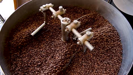Draufsicht-Auf-Frisch-Geröstete-Goldbraune-Arabica-Kaffeebohnen,-Die-Während-Des-Röstvorgangs-In-Einer-Industriellen-Kaffeeröstmaschine-Abkühlen
