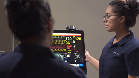Nurse-Student-Shows-How-to-Use-Vital-Signs-Machines