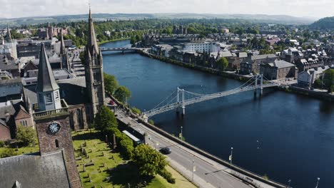 Aerial-shot-of-churches-lining-the-River-Ness-in-Scotland's-Inverness-region