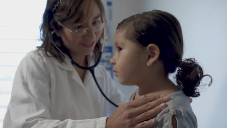 Doctor-Carefully-Listening-to-Little-Girl's-Heartbeat