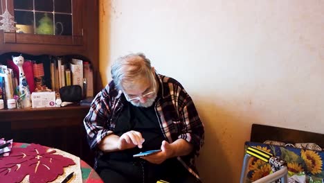 Alter-Grauhaariger-Mann-Tippt-Auf-Sein-Smartphone