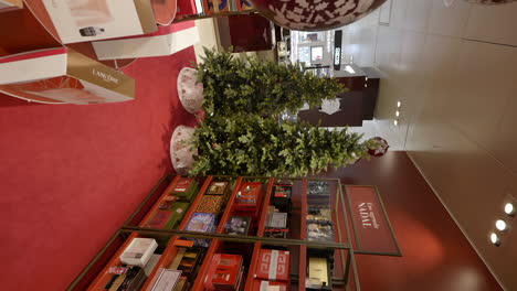 Vertical-video-of-luxury-store-decorated-for-Christmas,-dolly-in,-interior