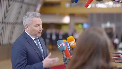 Austrian-Prime-Minister-Karl-Nehammer-talking-to-the-press-in-the-European-Council-building-during-EU-summit-in-Brussels,-Belgium