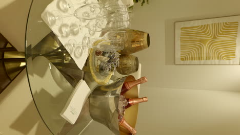 Vertical-video-of-champagne-glasses-and-bottles-on-glass-table,-shopping-mall