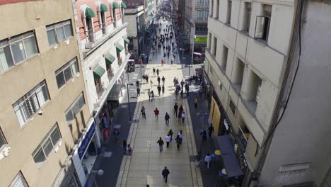 Aerial-reverse-overview-of-people-on-Madero-Pedestrian-Street,-in-sunny-Mexico