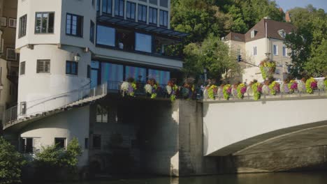 People-on-Bridge-and-Wall-in-Tubingen,-Germany-in-4K-Downtown-Home-of-Europes-Oldest-University-At-Sunset