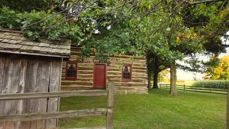 Backyard-of-the-cabin-and-fence-Historic-site-at-the-Peter-Whitmer-Farm-location-in-New-York-in-Seneca-County-near-Waterloo-Mormon-or-The-Church-of-Jesus-Christ-of-Latter-day-Saints