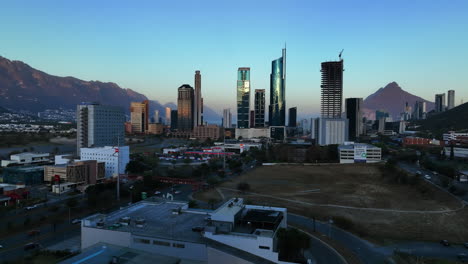Aerial-view-rising-towards-high-rise-in-the-San-Pedro-Garza-Garcia,-Nuevo-Leon,-Monterrey,-dusk-in-Mexico