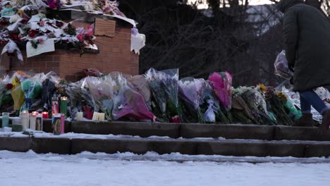 Michigan-State-University-Mass-shooting-memorial-at-The-Spartan-Statue-people-placing-flowers