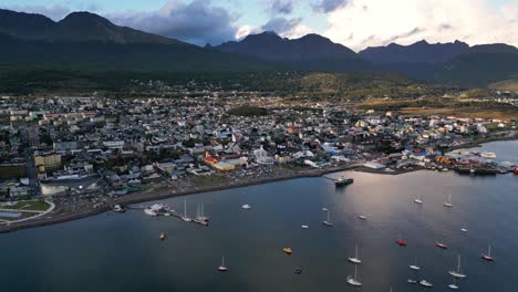 Aerial-Drone-Above-Ushuaia-Bay,-Patagonian-Port-in-Argentina,-Mountain-Subpolar-Forest-Landscape-and-Southernmost-City-in-The-World,-Boats-Docked