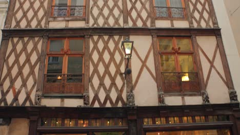 Exterior-Of-Half-Timbered-Building-In-Historic-Center-Of-Angers,-France---tilt-down