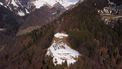 Aerial-View-Of-Snow-Covered-Hillside-With-Orobie-Cattedrale-With-Snow-Capped-Mountains-And-Valley-Forest