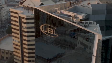 Aerial-View-Of-UBL-Logo-On-Side-Of-Head-Office-Skyscraper-In-Karachi