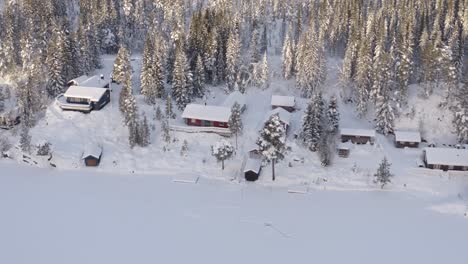 Idyllic-Countryside-Town-In-Snowdrift-Surrounded-By-Dense-Spruce-Forest