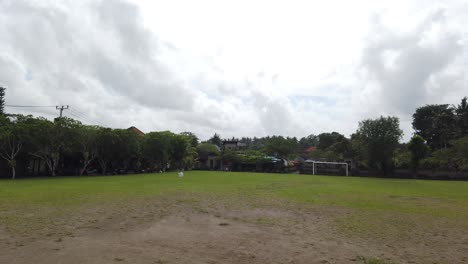 Nyuh-Kuning-Soccer-Field-in-South-Ubud,-Bali,-Asia,-Cloudy-Sky-Amateur-Sports-Location,-Local-Village-in-Balinese-Traditional-Weather,-Humble-Rusty-Grass
