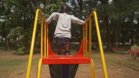Child-doing-the-slide-at-the-playground