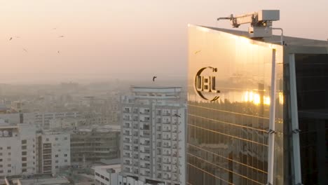 Aerial-View-Of-UBL-Logo-On-Side-Of-Head-Office-Skyscraper-In-Karachi