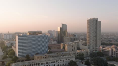 Aerial-View-Of-Habib-Bank-Plaza,-State-Life-And-United-Bank-Limited-Building-In-Karachi-Against-Orange-Sunset-Sky