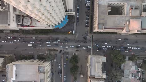 Aerial-Birds-Eye-View-Ascending-Beside-Habib-Bank-Plaza-In-Karachi-With-Traffic-Going-Past-Below