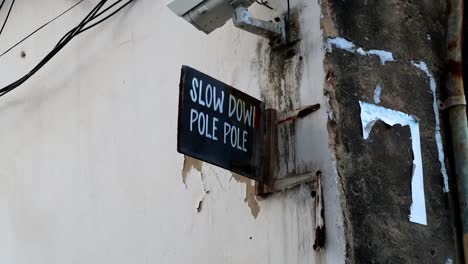 Zanzibar-street-velocity-sign-saying-Slow-Down-Pole-Pole