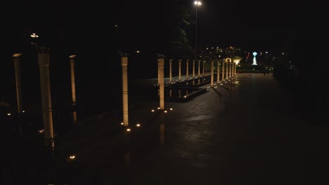 Two-rows-of-illuminated-columns-at-night-in-Lam-Vien-Square,-Da-Lat,-Vietnam