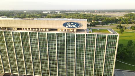 Ford-logo-on-office-building-top,-aerial-fly-backward-view