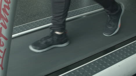 Close-Up-of-a-Man's-Feet-Walking-on-a-Treadmill