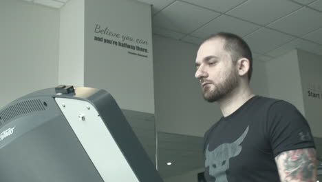 Close-Up-Low-Angle-of-a-Young-Man-Walking-on-a-Treadmill