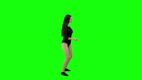 Side-view-of-a-female-dancer-dancing-in-front-of-a-green-screen-chroma-key