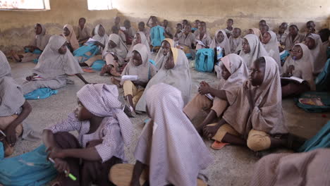 Students-in-Jimeta,-Nigeria-on-the-classroom-floor-at-a-school-lecture