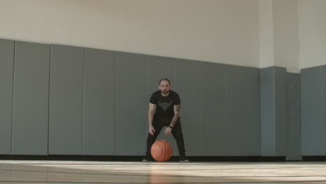 Wide-of-a-Man-Rolling-a-Basketball-Towards-the-Camera