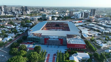 Aerial-drone-shot-flying-towards-Brisbane's-Suncorp-Stadium,-with-stunning-aerial-views-of-inside-the-stadium-where-workers-are-preparing-for-a-music-concert