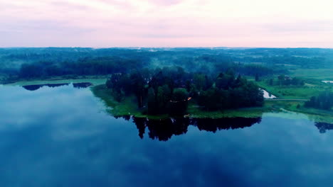 Aerial-flyover-natural-lake-with-forest-and-fog-in-the-morning,-4K