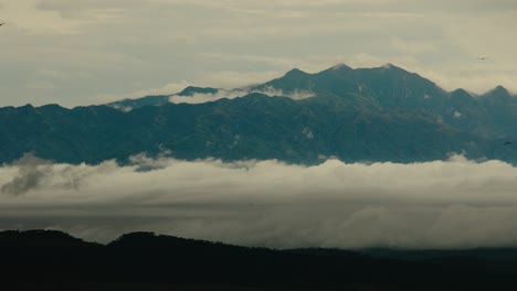 Low-lying-fog-over-African-landscape-with-mountain-range-in-background