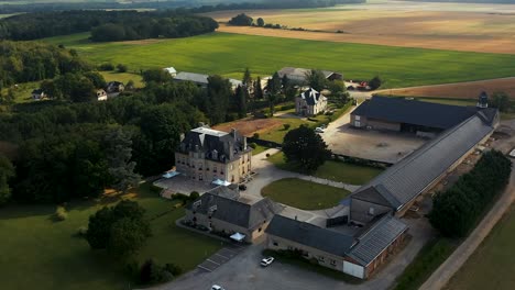 Aerial-view-of-a-castle-on-Bordeaux-in-the-south-of-France,-we-see-the-fields-behind
