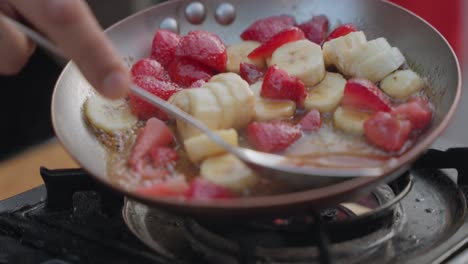 Stir-frying-fruits-in-pan-in-slow-motion-scene