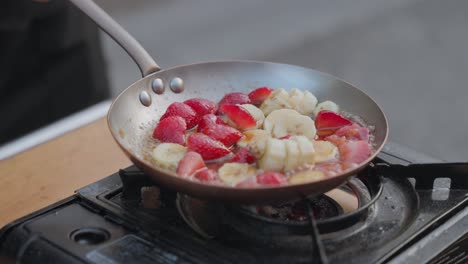 A-sizzling-hot-pan-frying-fresh-fruit-in-slow-motion
