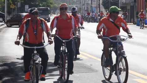 Large-group-of-bicycle-riders-in-San-Juan,-Puerto-Rico-on-a-bright-sunny-day