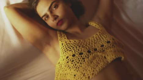 Exotic-woman-lying-on-bed,-seductive-cinematic-zoom-of-flirt-girl-with-red-lips