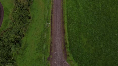 Stand-still-aerial-view-of-a-car-driving-through-Machachi-area,-Ecuador