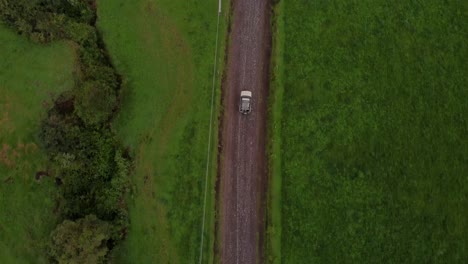 Topview-aerial-of-a-car-driving-through-Machachi-nature-area,-Ecuador