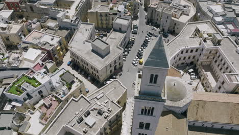 Aerial-footage-rotating-around-the-cross-and-steeple-of-Basilica-Cattedrale-Metropolitana-Primaziale-San-Sabino-in-Bari,-Italy