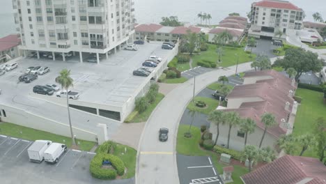 Porsche-drives-in-St-Pete-Beach-luxury-residential-seaside-district,-aerial-view
