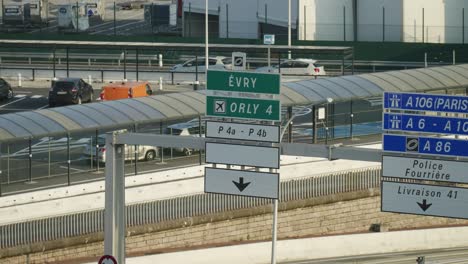 Panning-down-from-Paris-Orly-airport-street-sign-to-highway